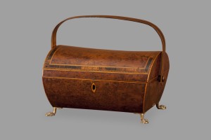 A wooden box with gold feet and handles.