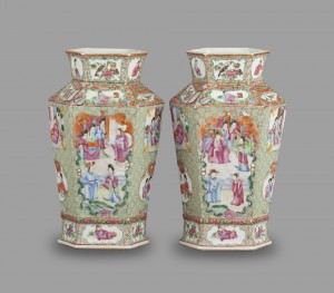 A pair of large vases with scenes on them.