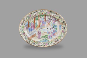 A large oval plate with an oriental scene.