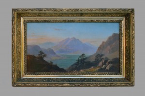A painting of mountains and water in an ornate frame.